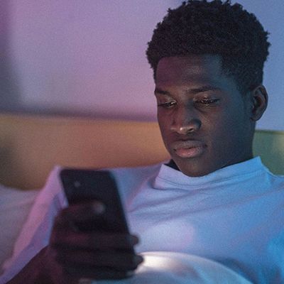 Photo of a young man on a smartphone.