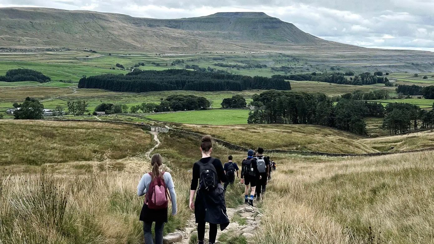 Image of a group of hikers walking the Yorkshire Three Peaks trail