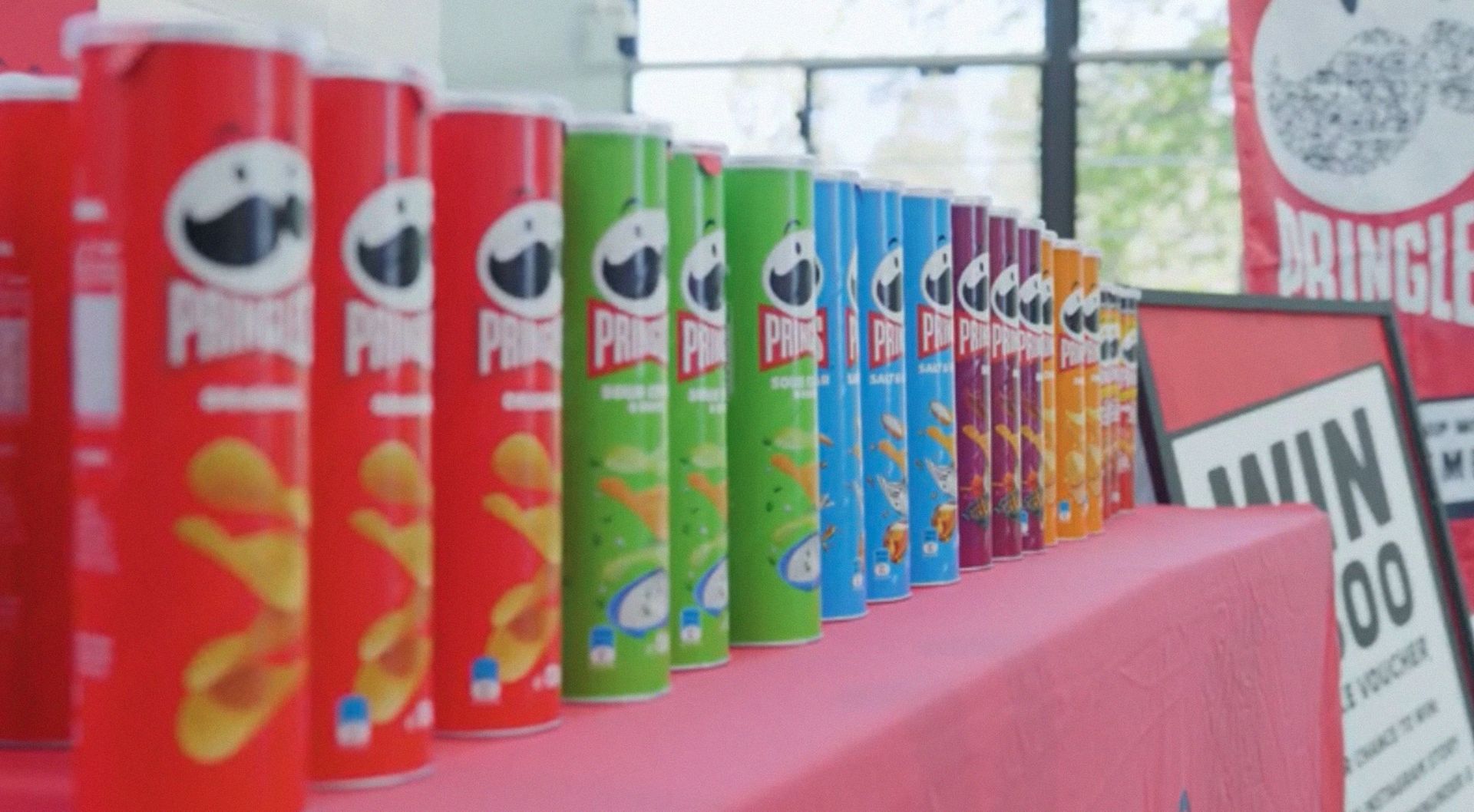 Rows of Pringles cans lined up on a table 