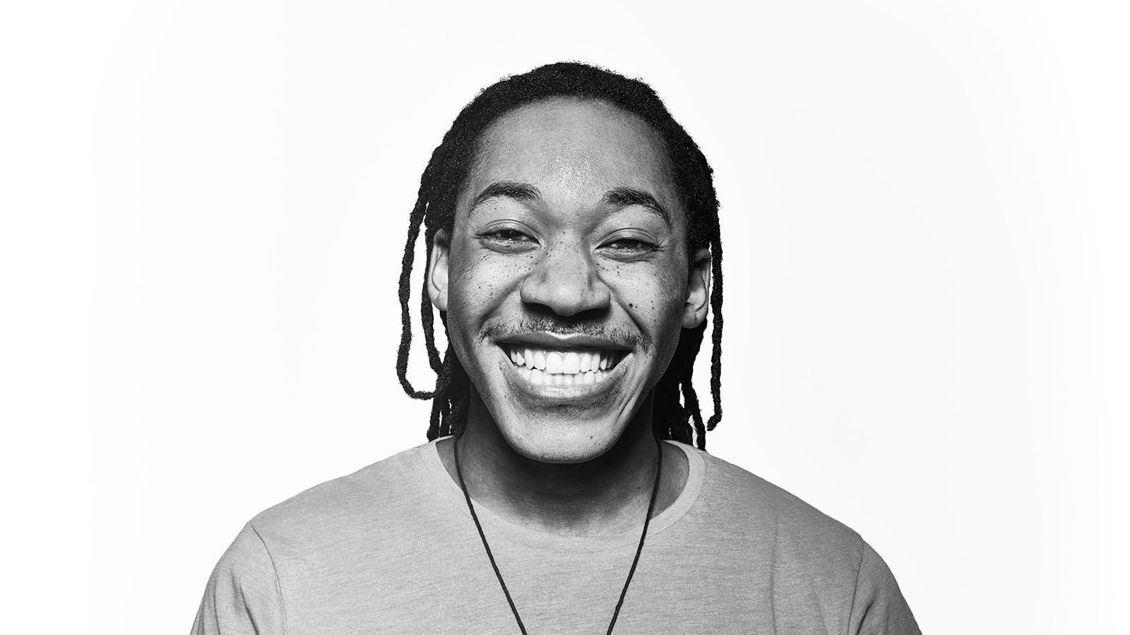 Smiling man with superb moustache looking to camera.