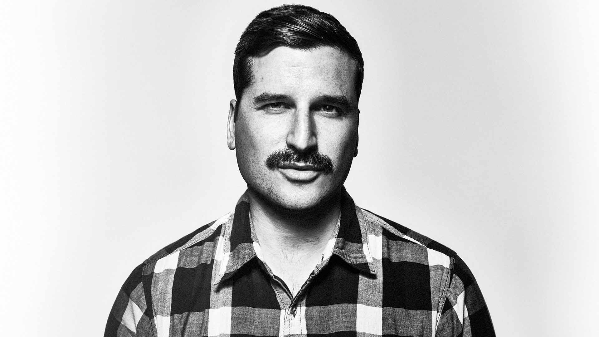 Smiling man looking to camera.