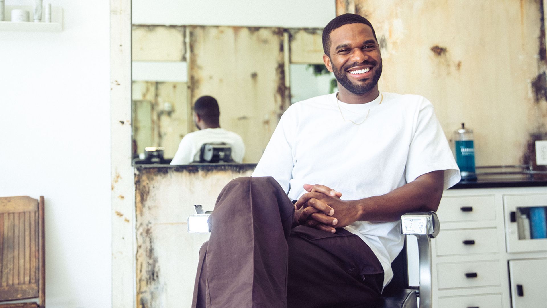 A smiling young man named Bradford joined us at an LA barbershop. Here he's seen sat down in the barber chair