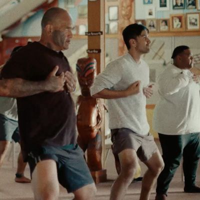 Māori men in sports gear performing a spectacular Haka.