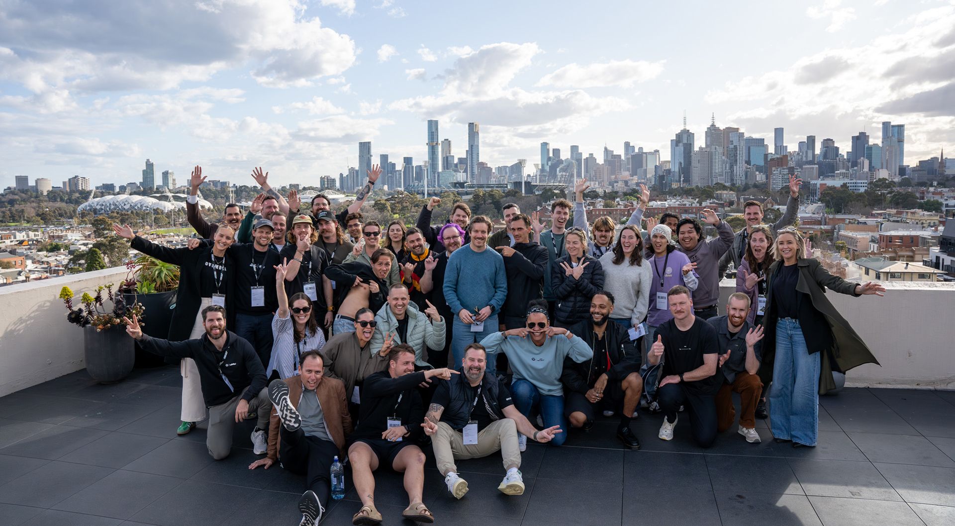 A group of people posing together on a rooftop for Movember.