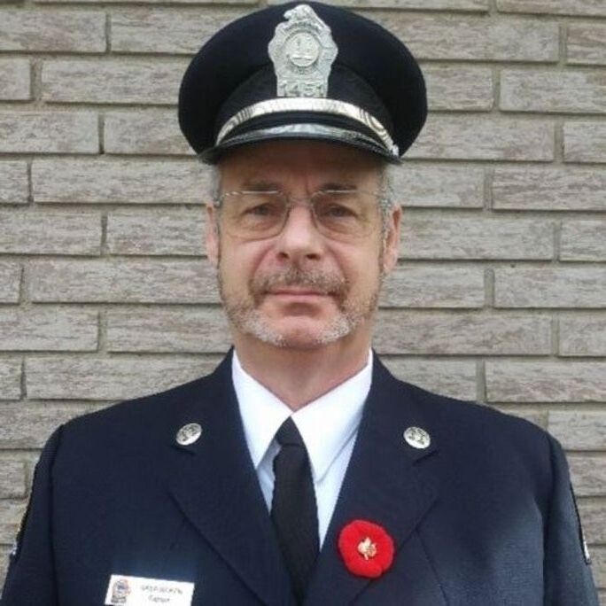 Photo of a Canadian fire fighter in dress uniform, looking to camera.