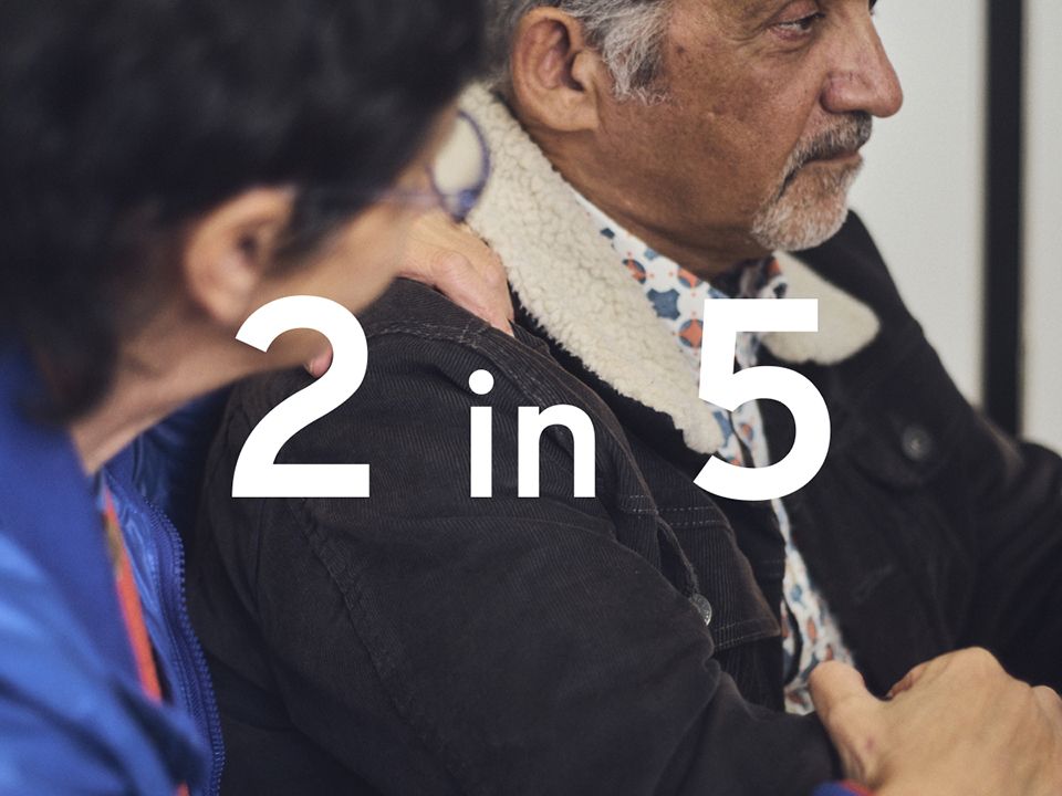 Dramatic photo of an elderly man receiving bad medical news while sitting next to his spouse. The figure "2 in 5" is superimposed in large white text.