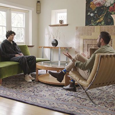 A photo of a therapist in conversation with a male patient.