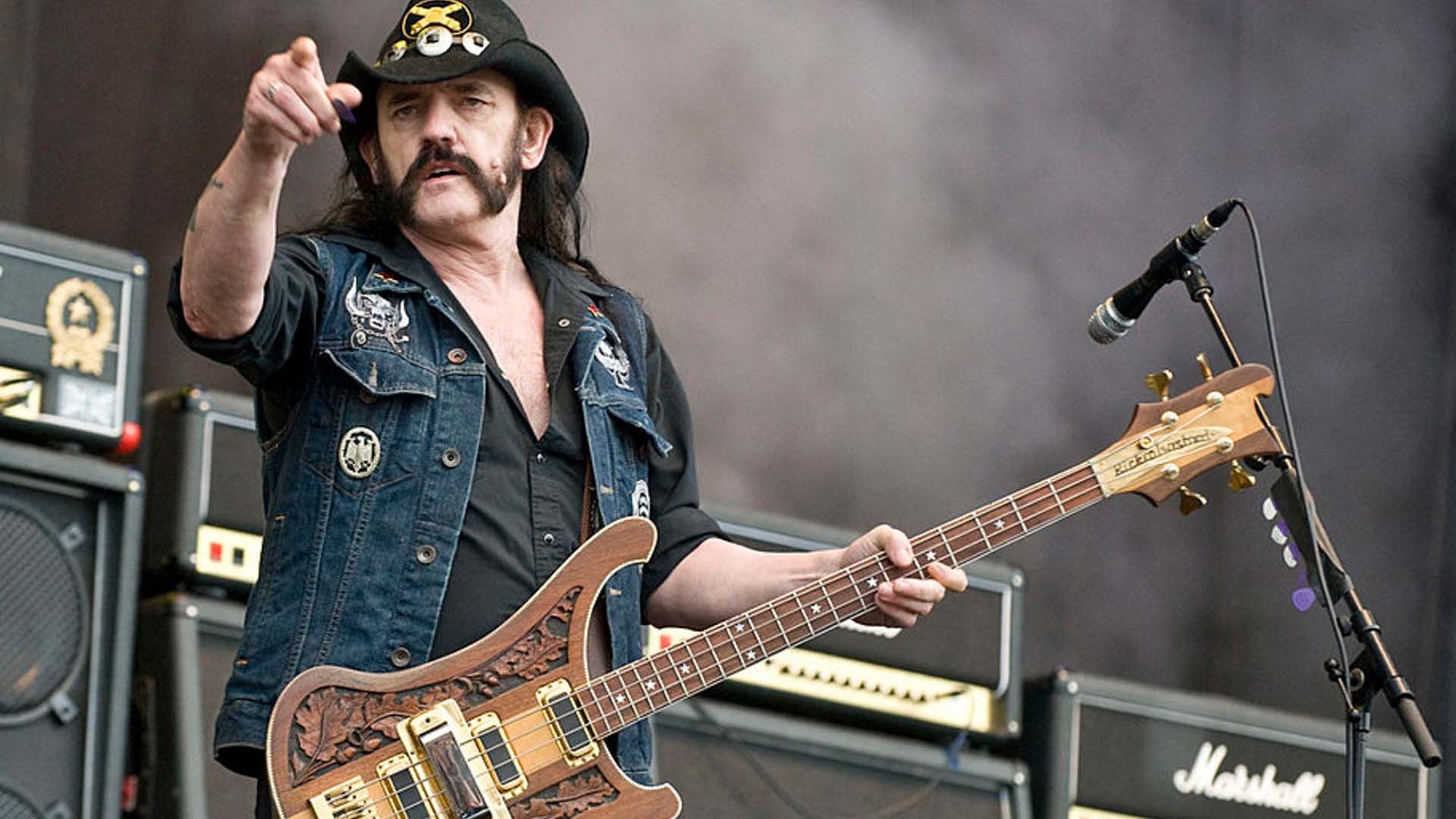 Photo of legendary rock n' roll frontman, Lemmy from Motörhead, performing live on stage.
