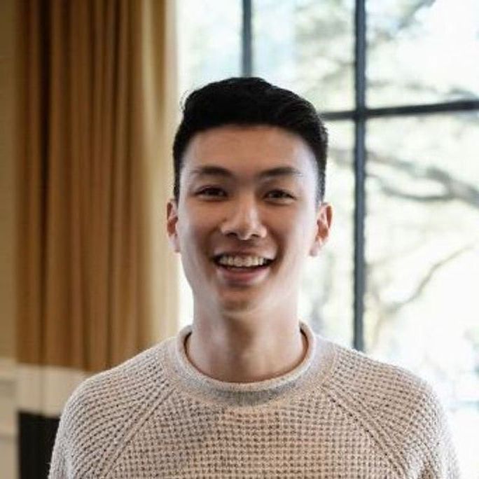 Portrait photo of a handsome young man smiling to camera.