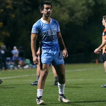 Photo of an athletic man on a sport field, wearing a soccer outfit.