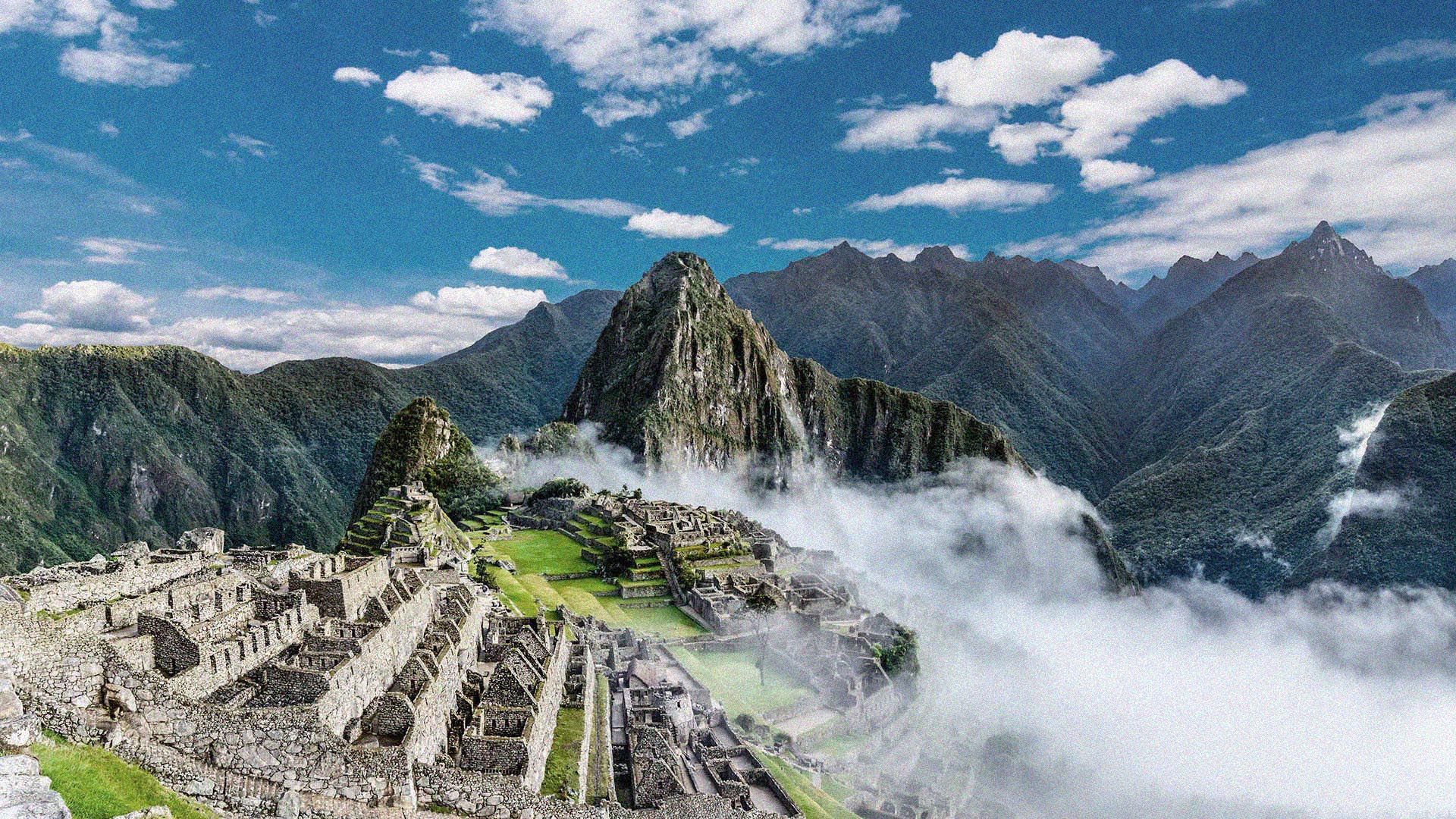 Epic, wide photo showing the stunning view of the ancient archaeological site of Machu Picchu in Peru.
