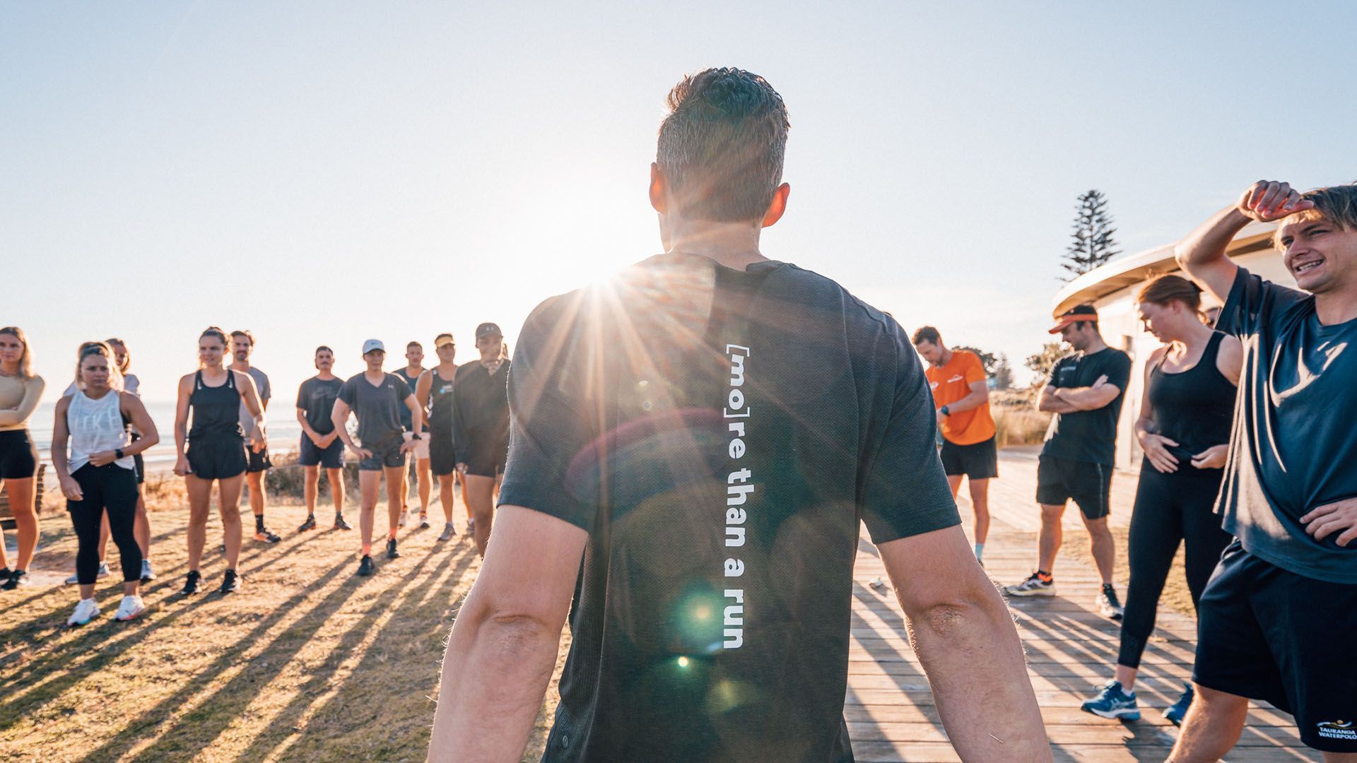 Photo of a running group preparing to raise money for Movember, assembling at sunrise.