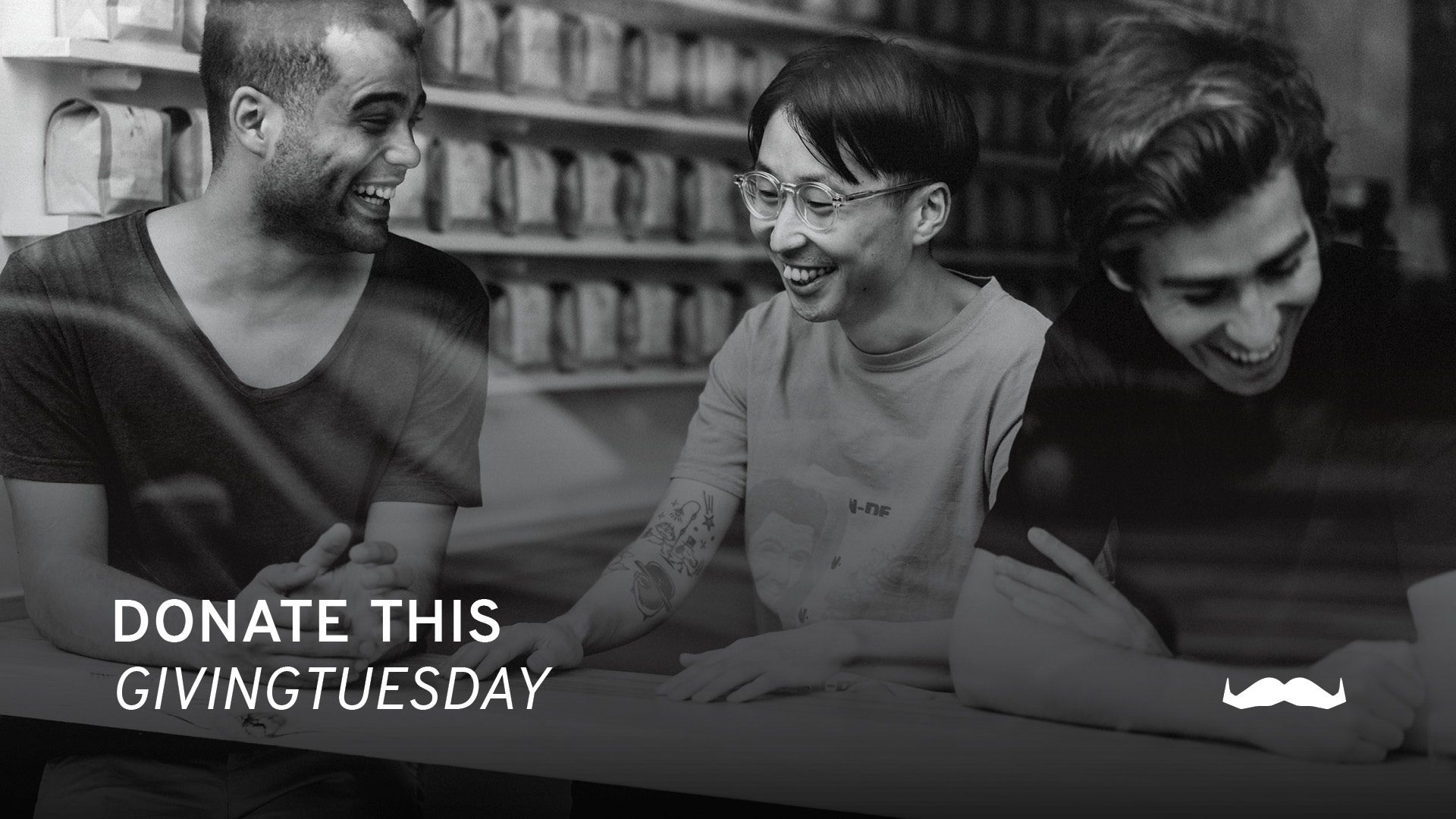 A black and white photo of three guys with superimposed text which says "Donate this GivingTuesday".