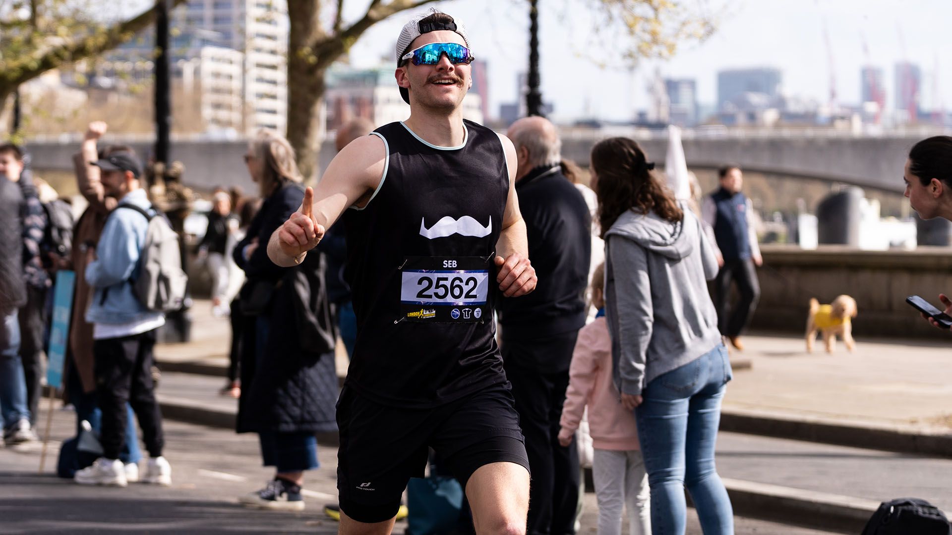 Photo of marathon runner, smiling to camera and wearing Movember-branded attire.