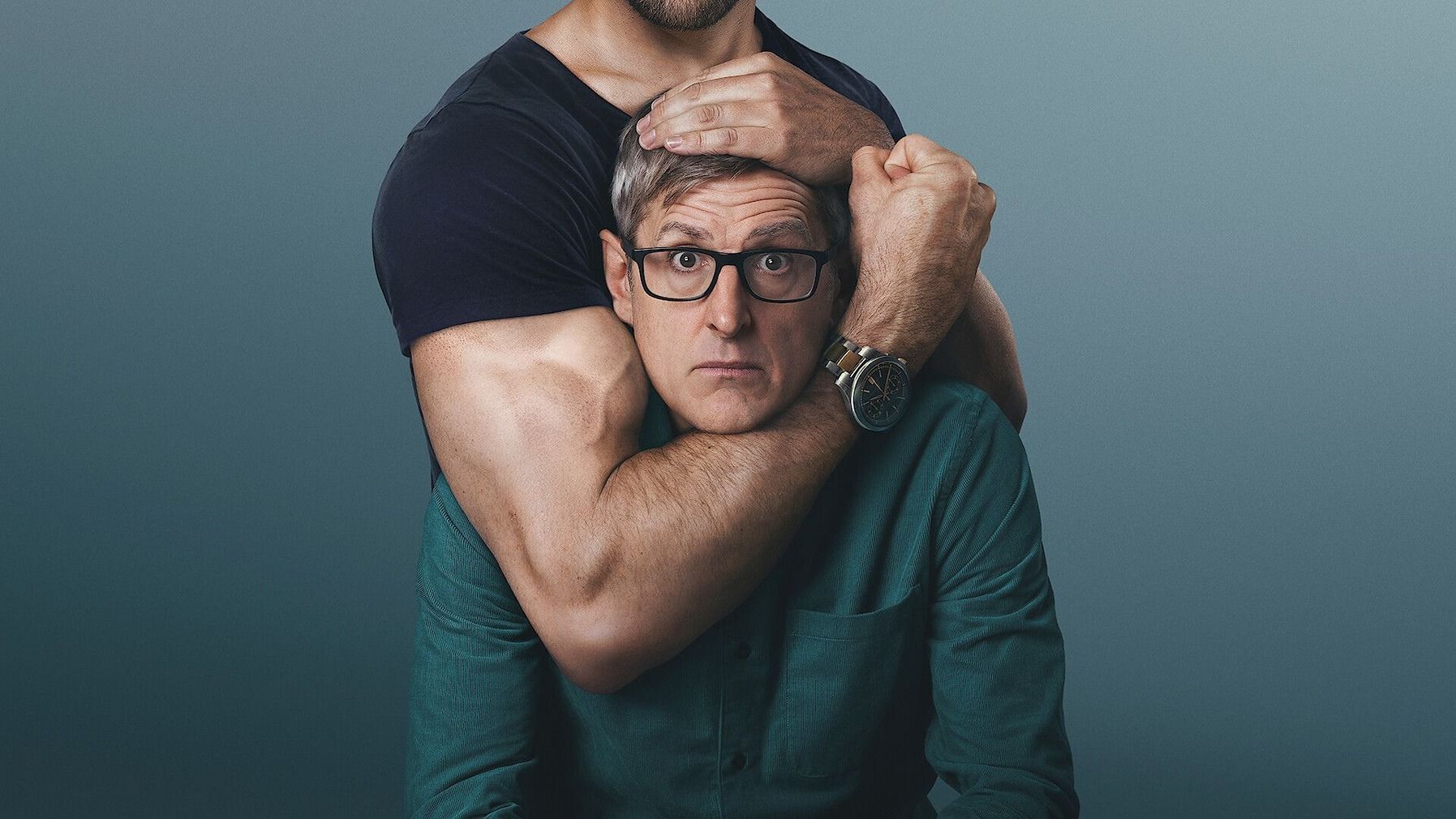 Louis Theroux being held by a man around the neck