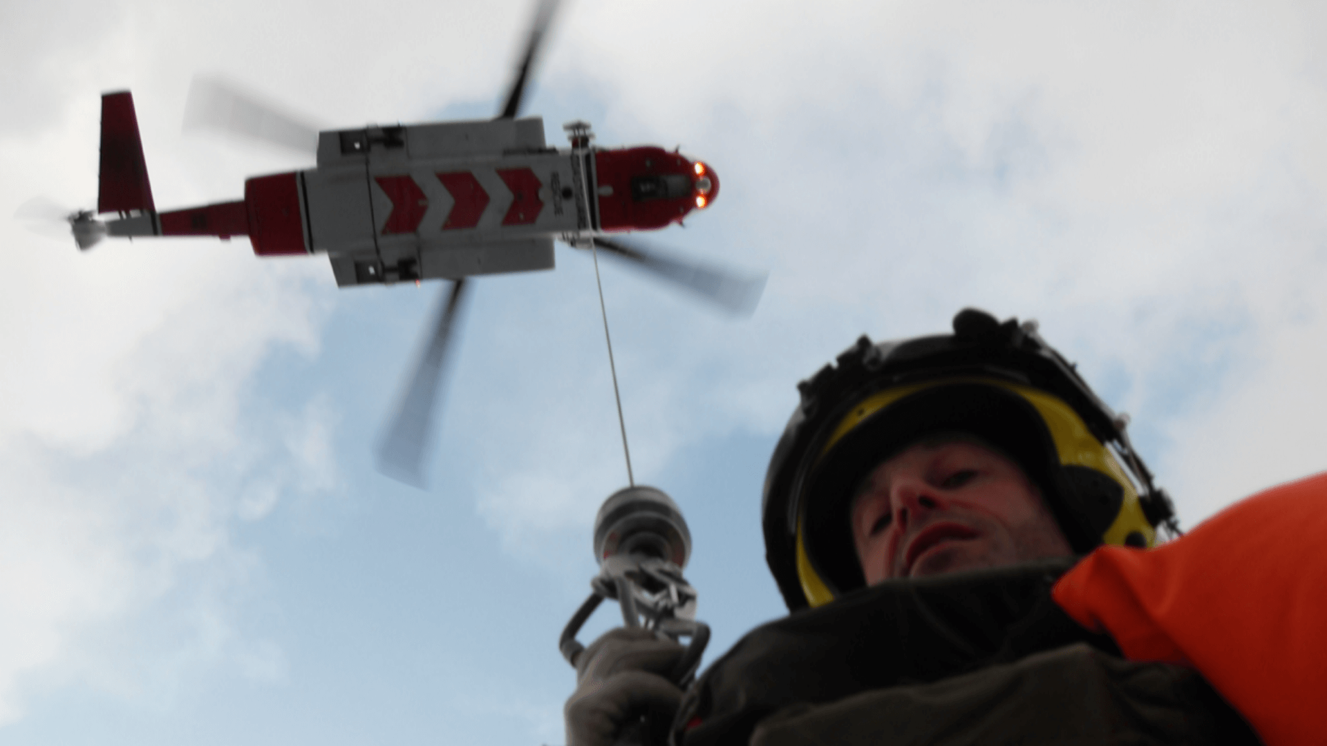 Man dangling from helicopter